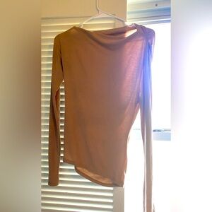 Light brown long sleeve shirt, slight off the shoulder fee on one side